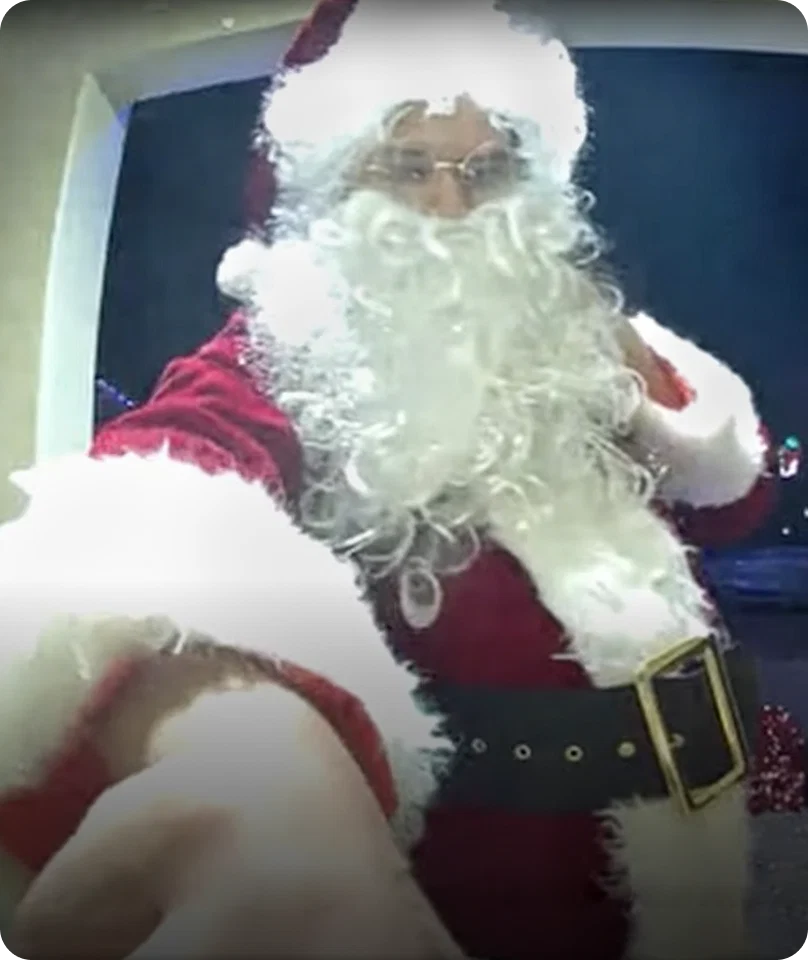 eufy Santa with curly white beard pressing doorbell